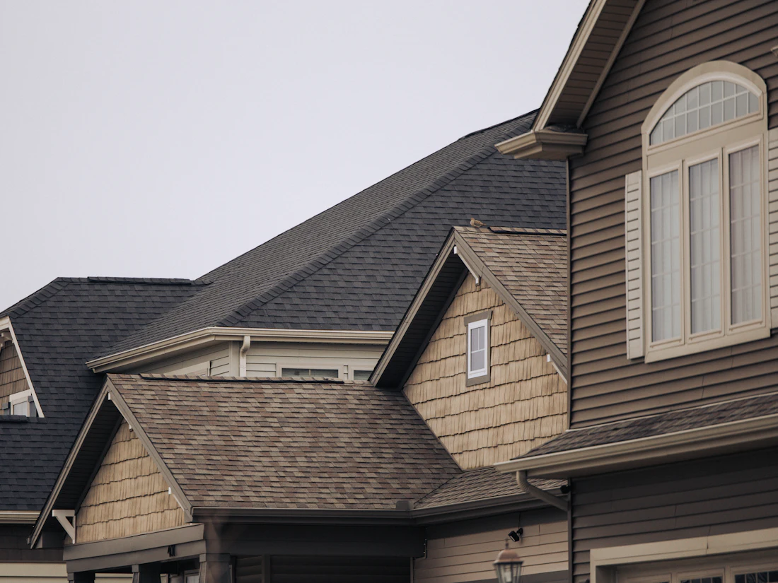 Newer two-story homes with intersecting gables and architectural shingles