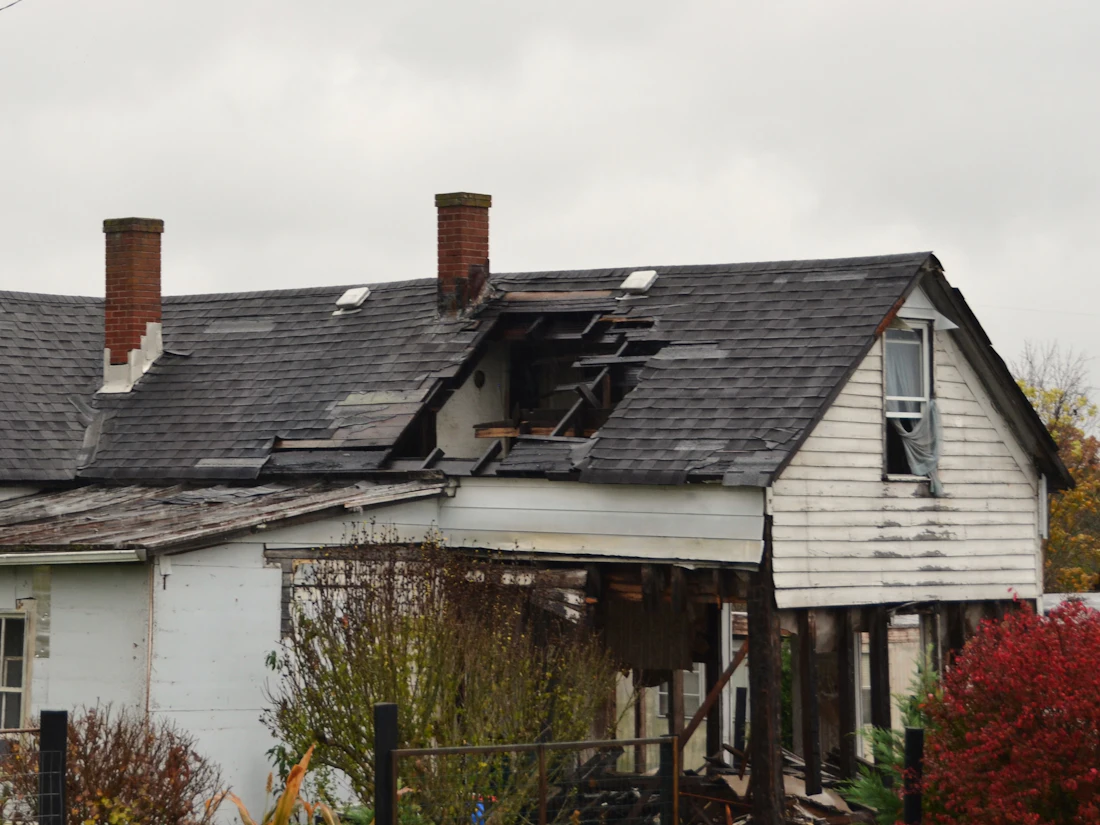House with a badly damaged roof and missing shingles