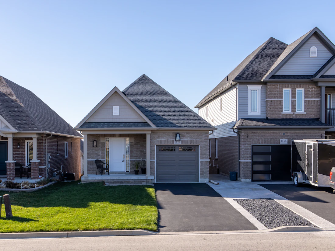 Suburban homes with hip and gable roofs, architectural shingles and attached garages